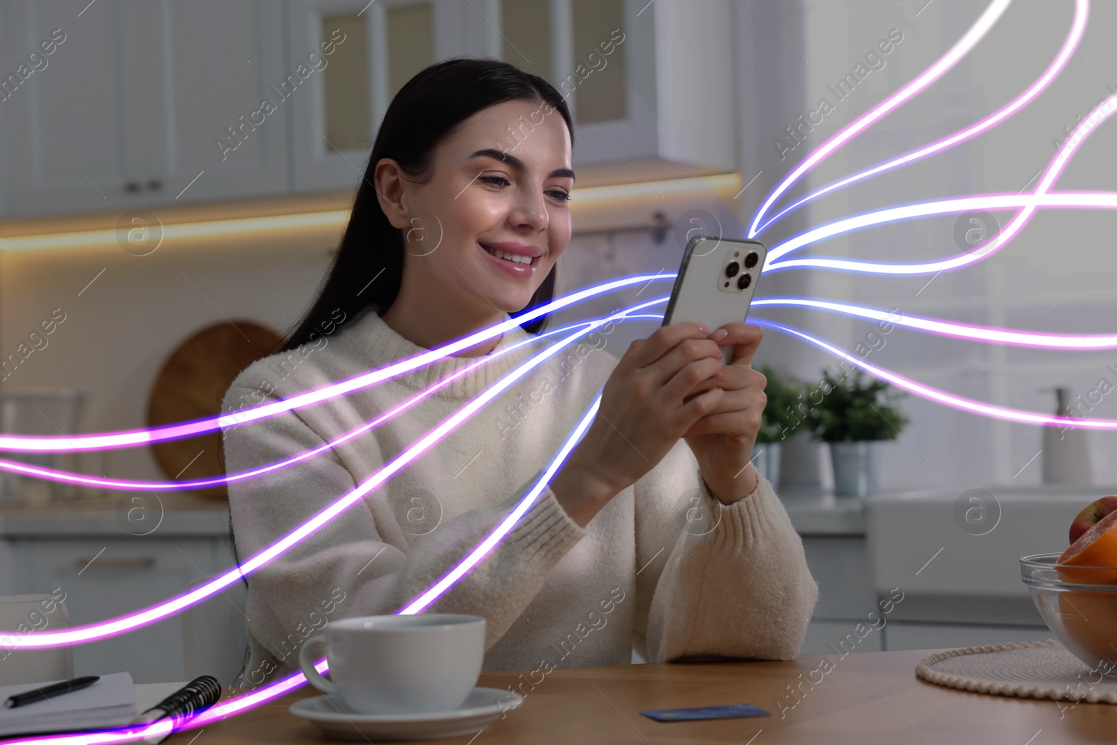 Image of Happy woman using mobile phone at home. Bright lines coming out of device symbolizing high speed internet