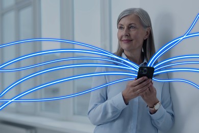 Image of Happy woman using mobile phone indoors. Bright lines coming out of device symbolizing high speed internet