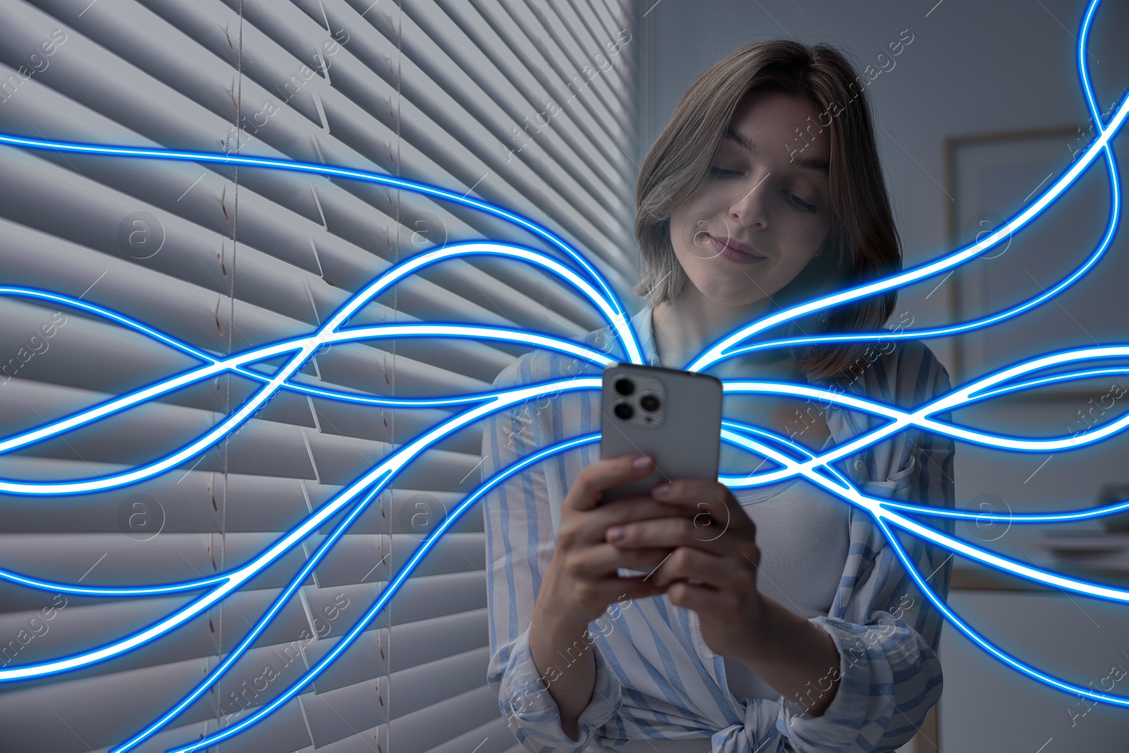 Image of Woman using mobile phone indoors. Bright lines coming out of device symbolizing high speed internet