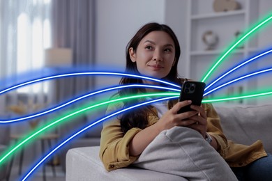 Image of Woman using mobile phone indoors. Bright lines coming out of device symbolizing high speed internet