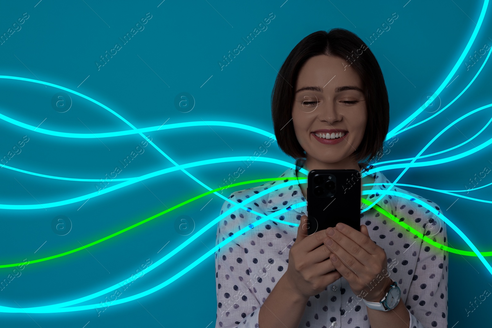 Image of Happy woman using mobile phone on blue background. Bright lines coming out of device symbolizing high speed internet