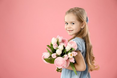 Cute little girl with bouquet of beautiful spring flowers on pink background, space for text