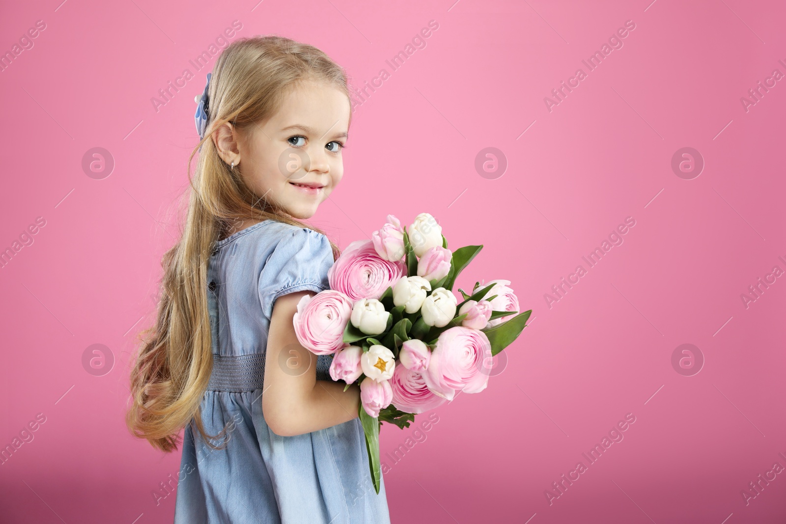 Photo of Cute little girl with bouquet of beautiful spring flowers on pink background, space for text