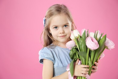 Photo of Cute little girl with bouquet of beautiful spring flowers on pink background