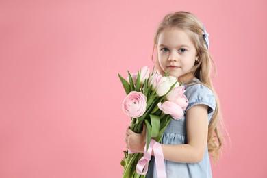 Cute little girl with bouquet of beautiful spring flowers on pink background, space for text