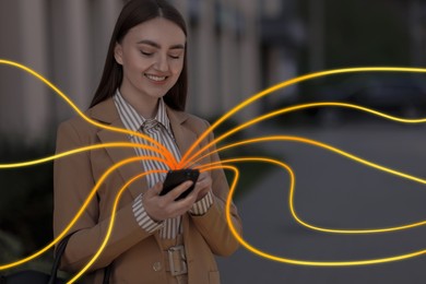 Image of Happy woman using mobile phone outdoors. Bright lines coming out of device symbolizing high speed internet