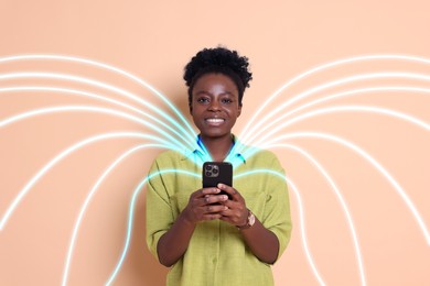 Image of Happy woman using mobile phone on beige background. Bright lines coming out of device symbolizing high speed internet