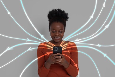 Image of Happy woman using mobile phone on grey background. Bright lines coming out of device symbolizing high speed internet