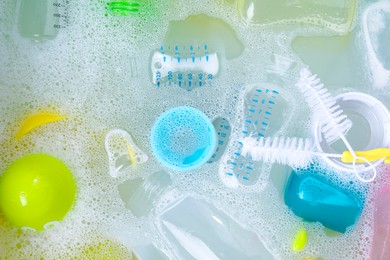 Photo of Washing feeding bottles in sink, top view