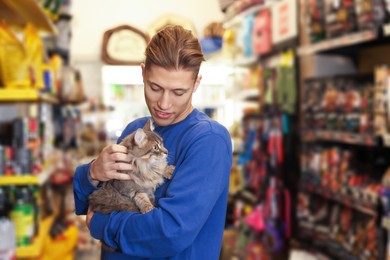 Photo of Man with his cute cat in pet shop