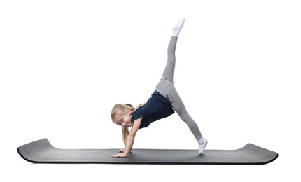 Photo of Little girl exercising on fitness mat against white background. Sport activity