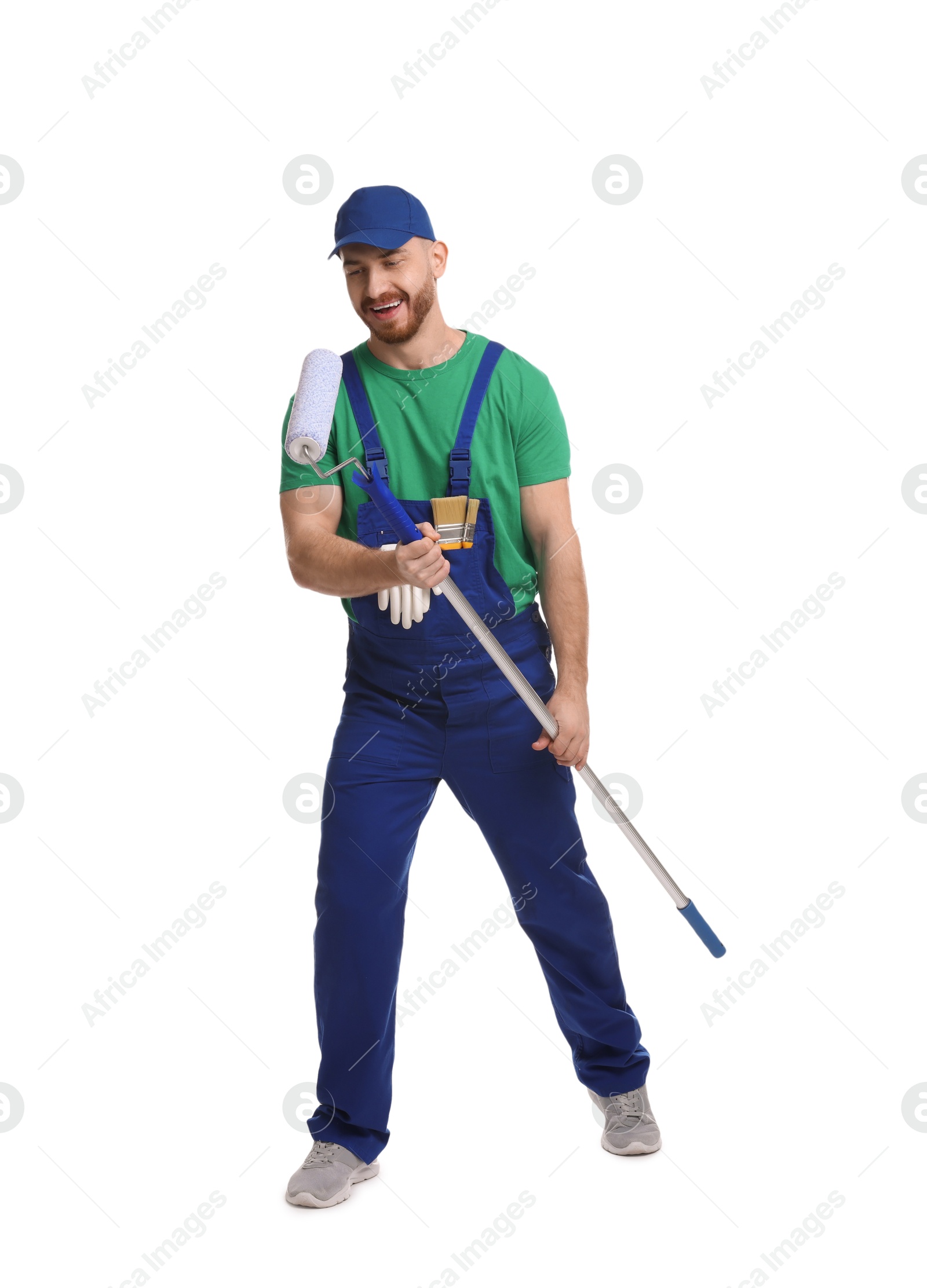 Photo of Professional painter with roller having fun on white background