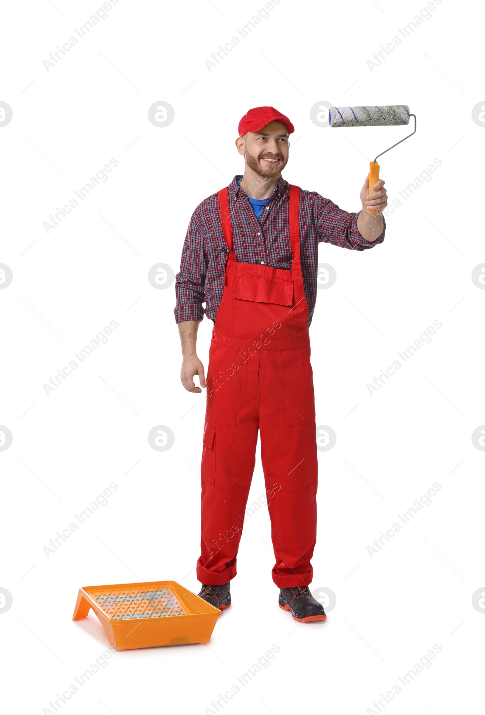 Photo of Professional painter with roller and tray working on white background