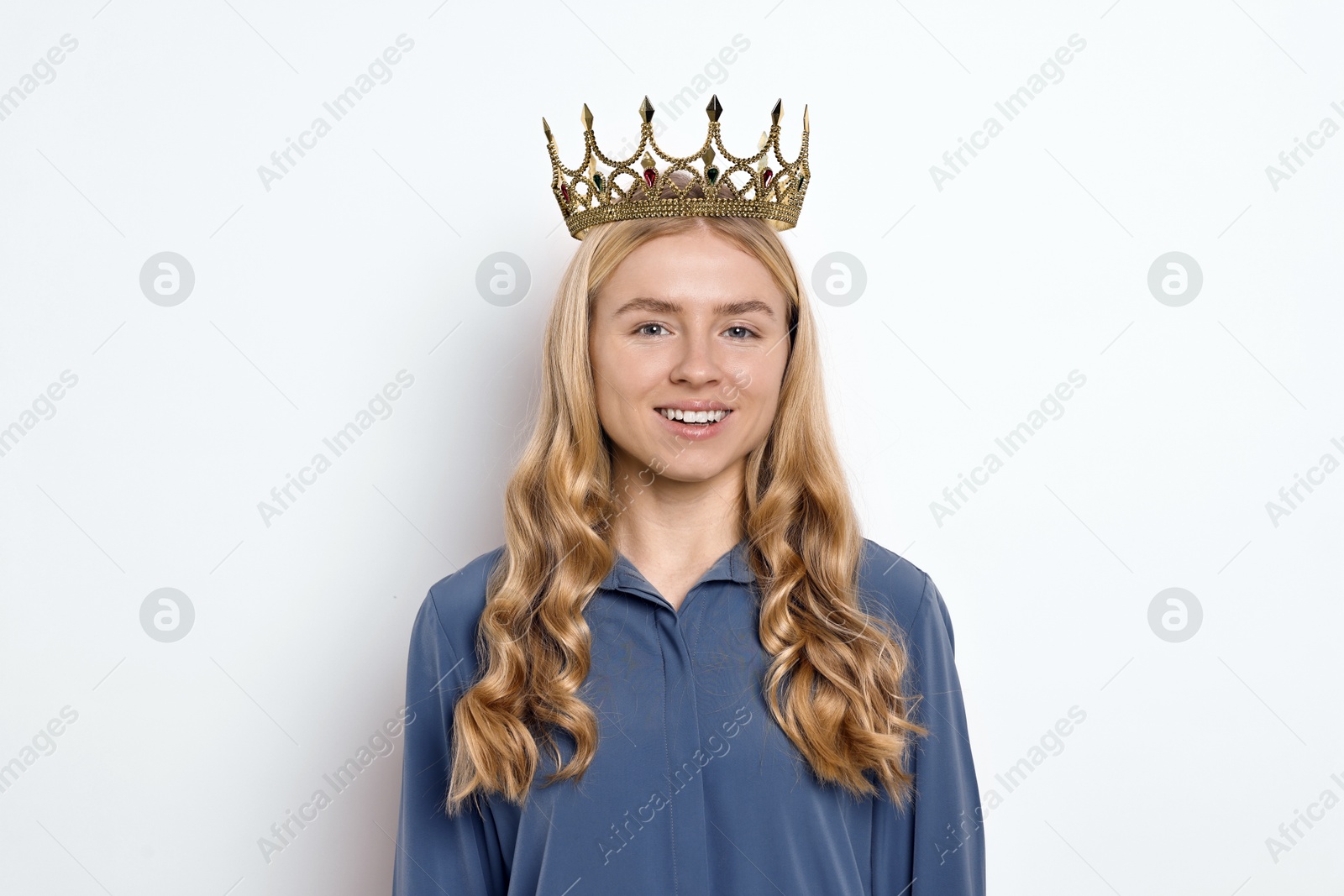 Photo of Smiling woman in elegant crown on light background