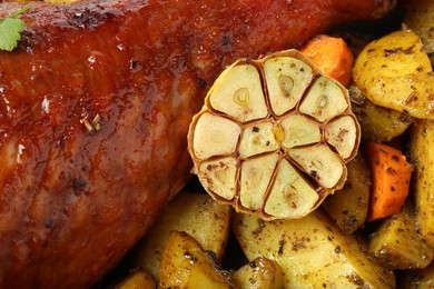 Photo of Baked turkey drumstick and vegetables as background, closeup