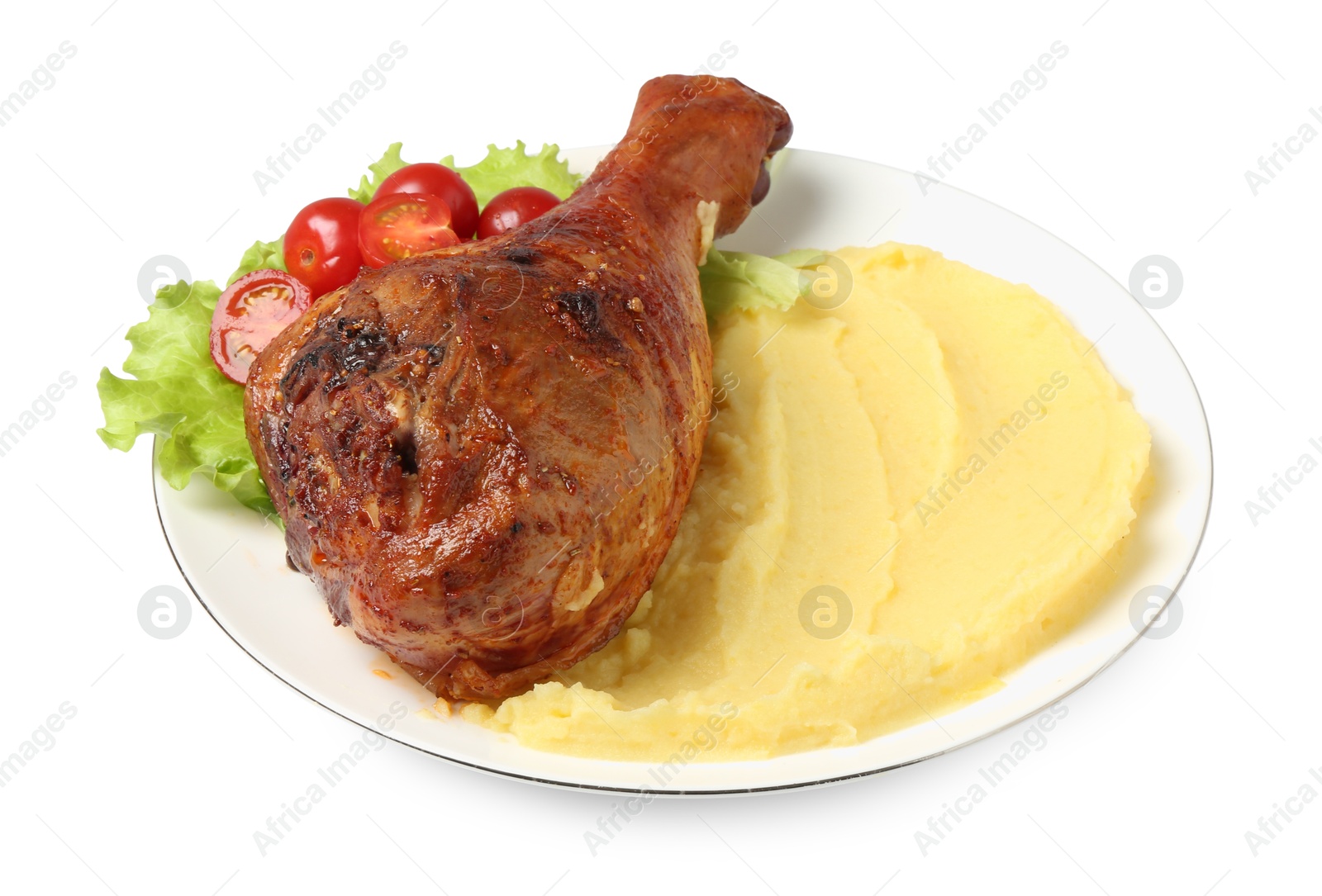 Photo of Baked turkey drumstick with mashed potato and tomatoes isolated on white