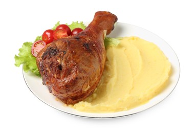 Photo of Baked turkey drumstick with mashed potato and tomatoes isolated on white