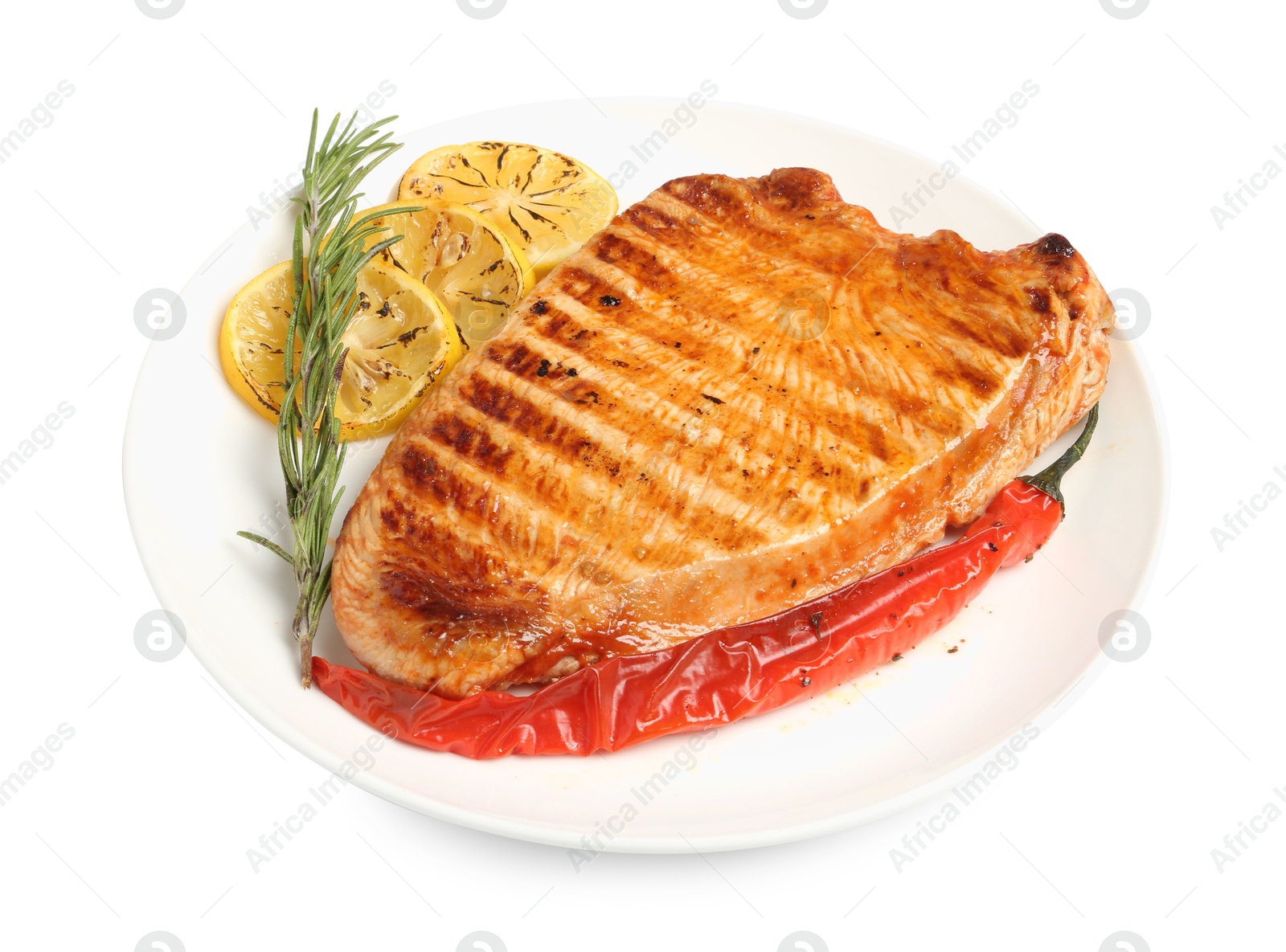 Photo of Delicious grilled turkey breast with lemon slices, chili pepper and rosemary isolated on white