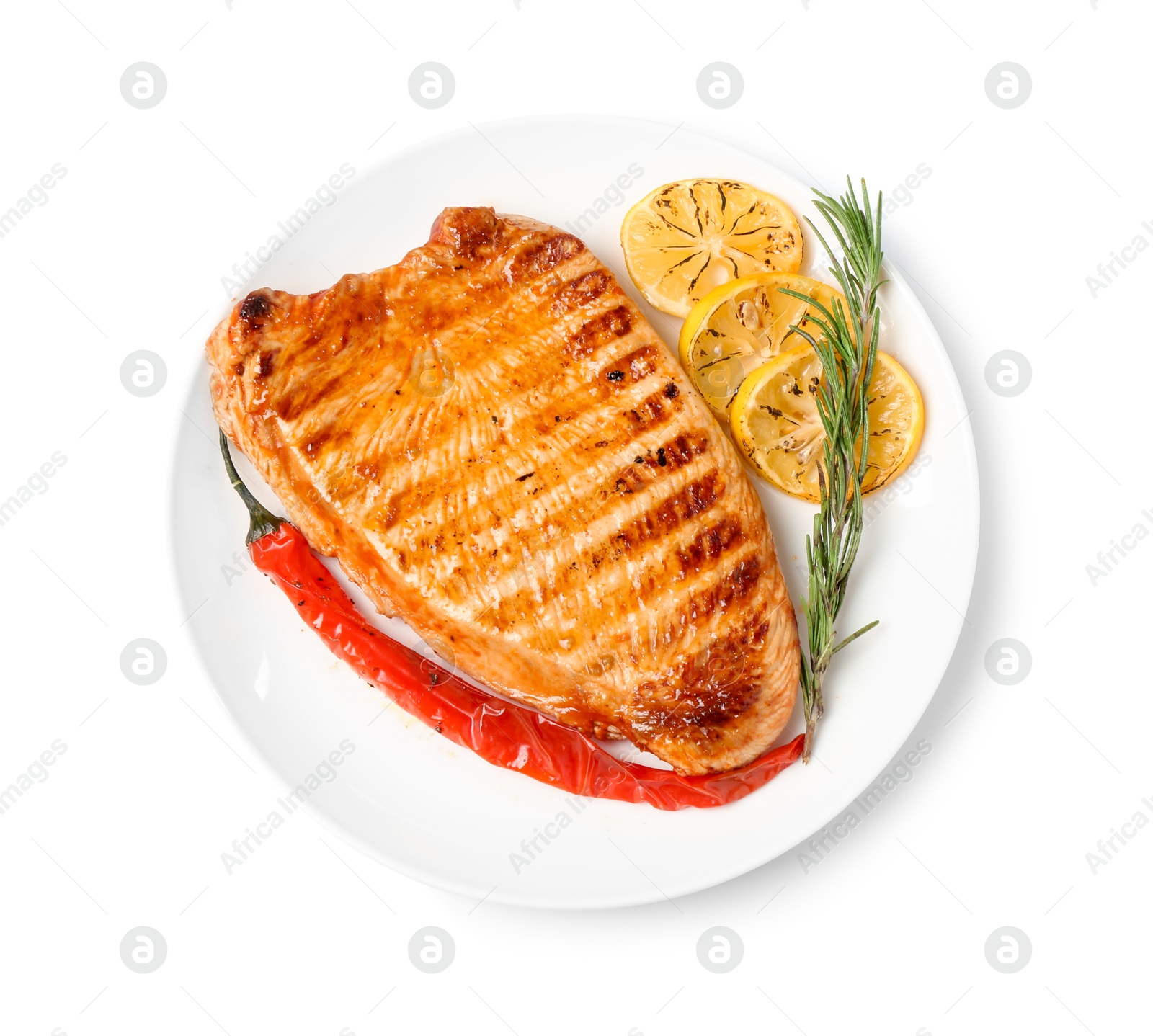 Photo of Delicious grilled turkey breast with lemon slices, chili pepper and rosemary isolated on white, top view