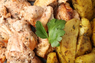 Photo of Pieces of delicious baked turkey and potatoes as background, closeup