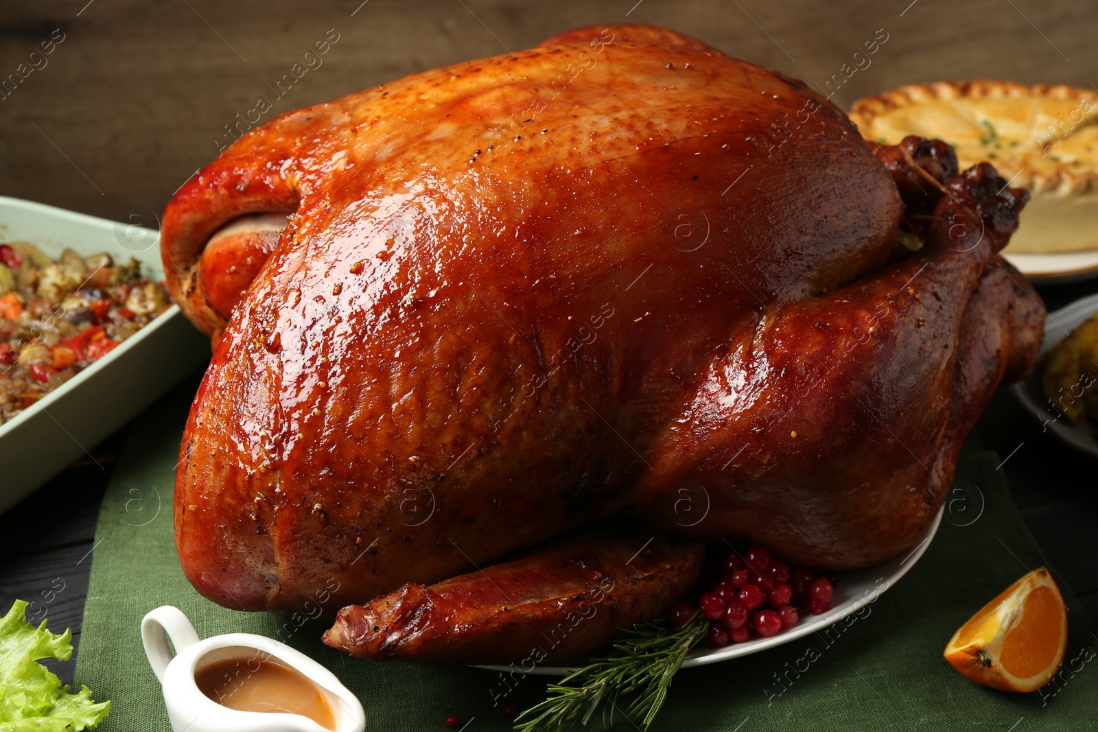 Photo of Whole baked turkey and other dishes served on table, closeup