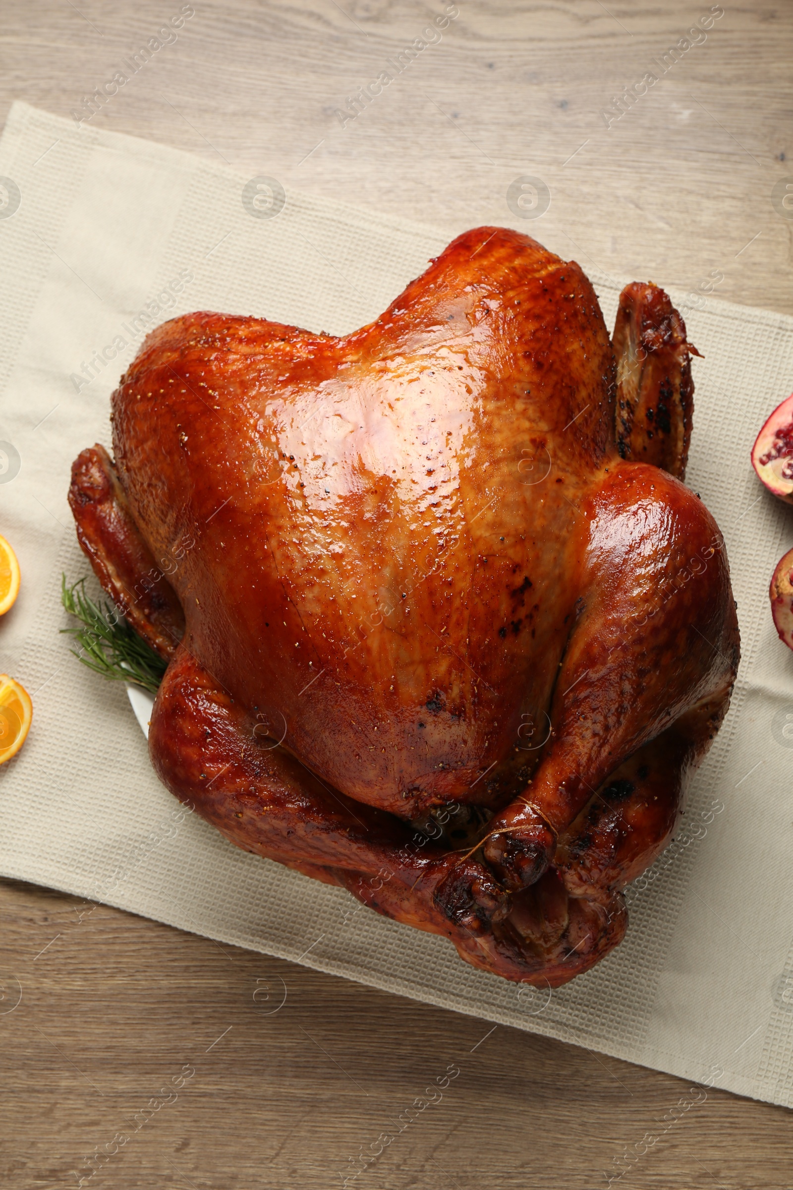 Photo of Whole baked turkey on wooden table, top view