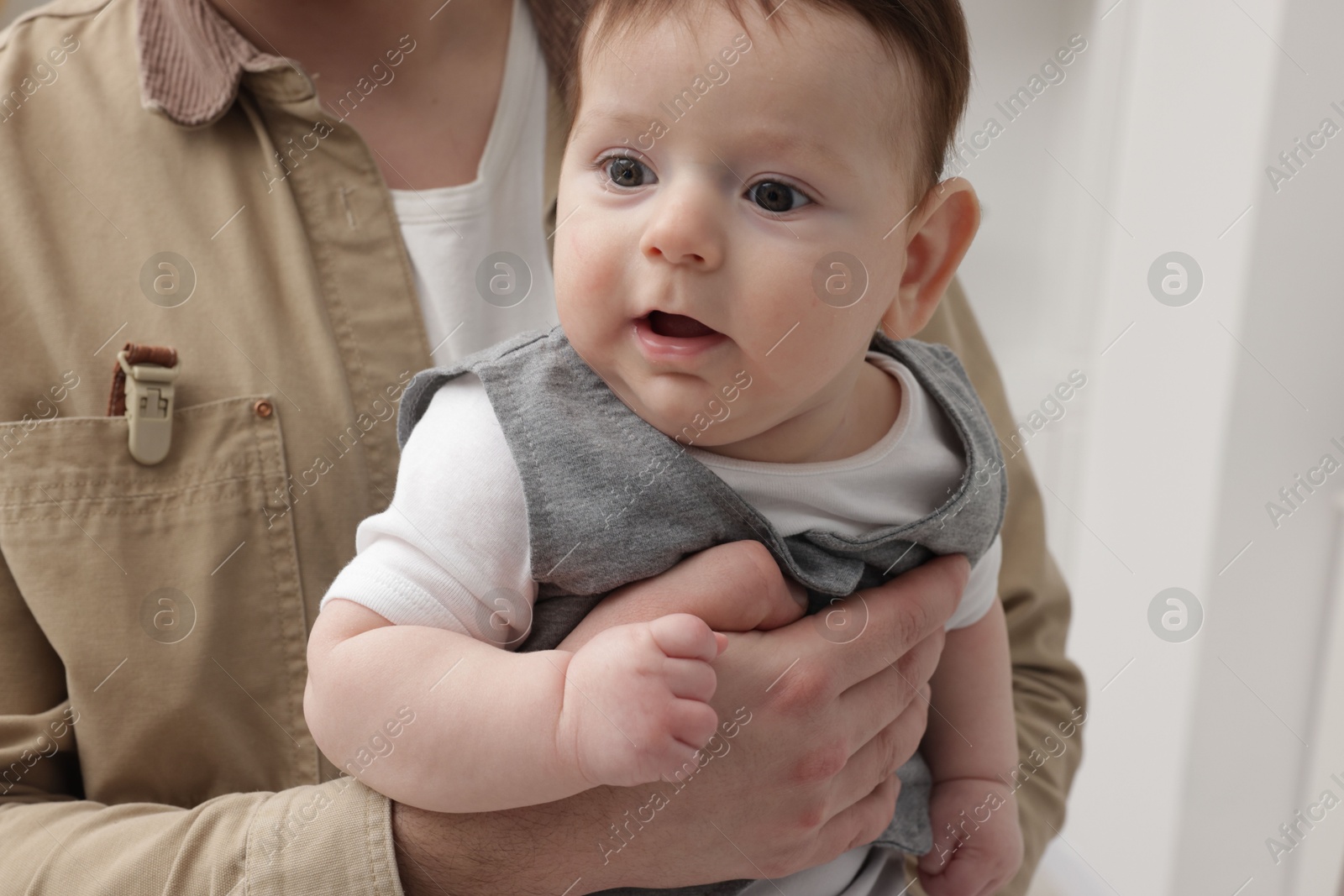 Photo of Mother holding her little baby at home, closeup