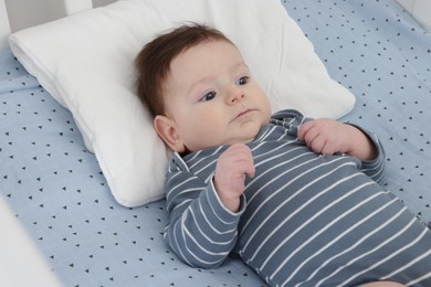 Photo of Cute little baby in crib at home