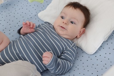 Photo of Cute little baby in crib at home