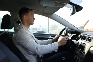 Driver behind steering wheel of modern car