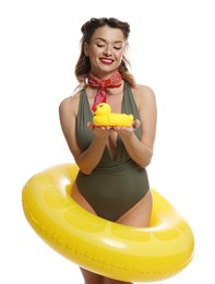 Photo of Happy pin-up woman in swimsuit with rubber duck and inflatable ring on white background