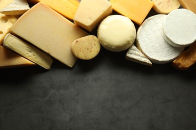 Photo of Different types of cheese on grey table, flat lay. Space for text