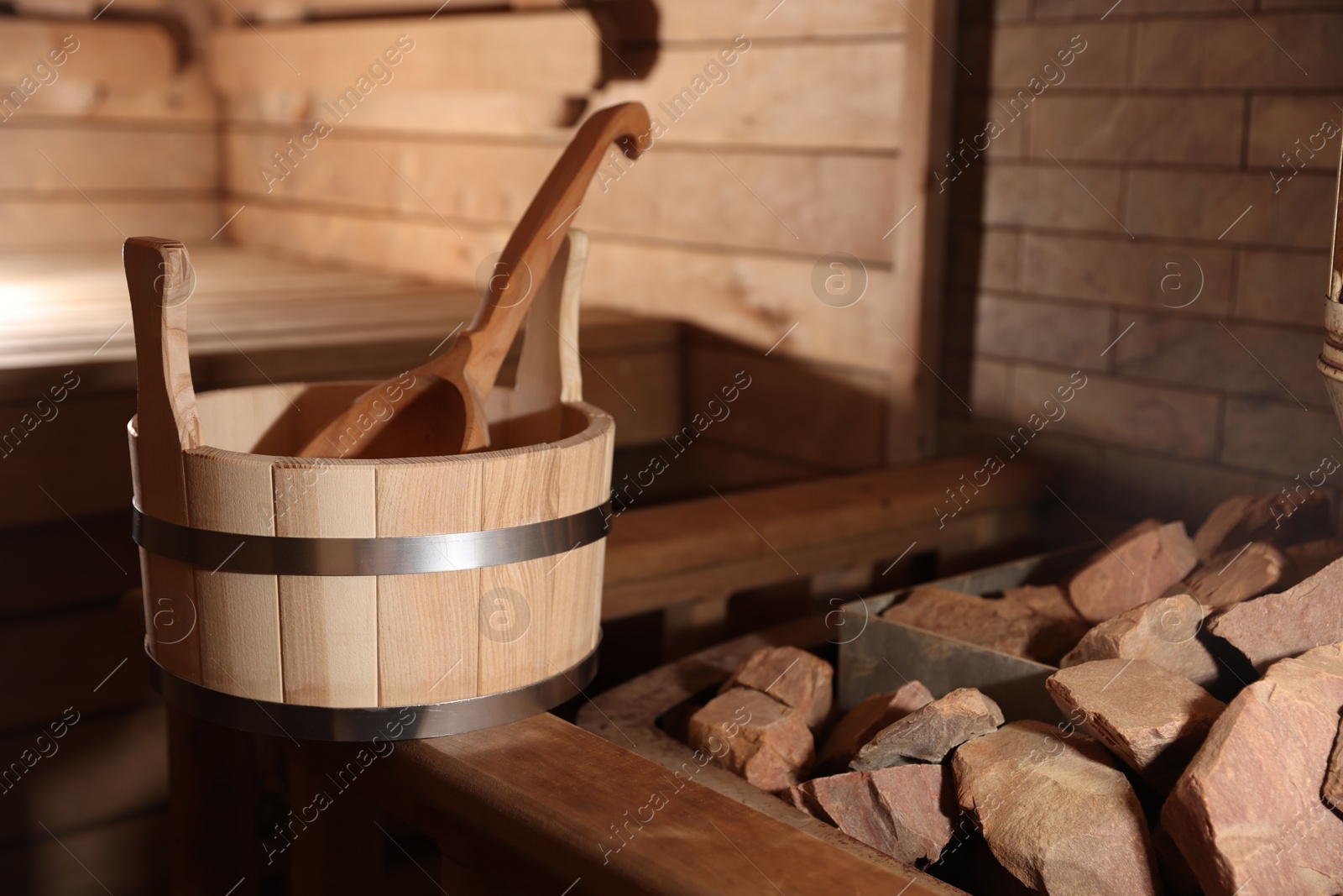 Photo of Bucket, ladle and hot rocks in sauna