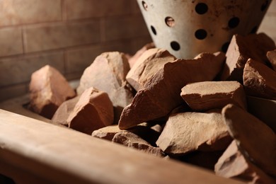 Photo of Stove with hot rocks in sauna, closeup