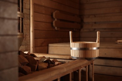 Photo of Bucket and stove with hot rocks in sauna