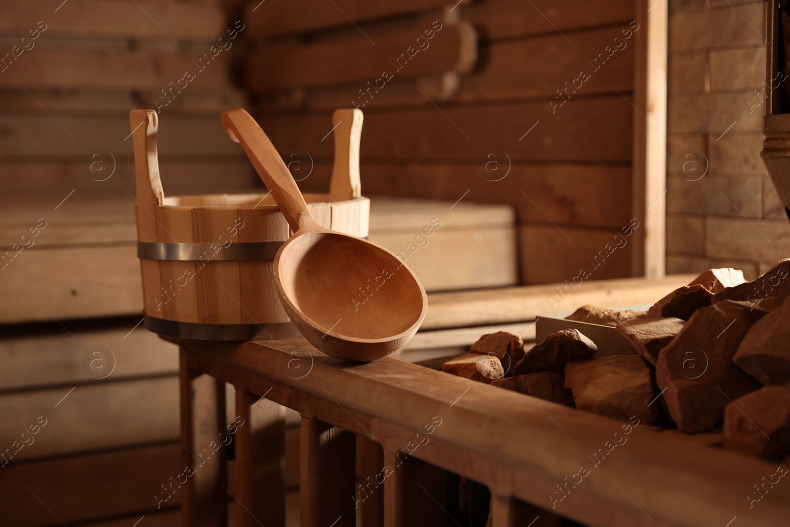 Photo of Bucket, ladle and hot rocks in sauna