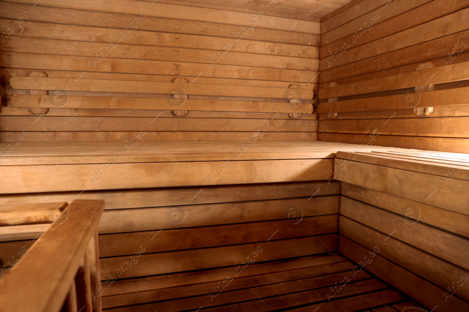 Photo of Empty wooden sauna with bench. Luxury relax