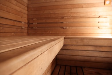 Photo of Empty wooden sauna with bench. Luxury relax