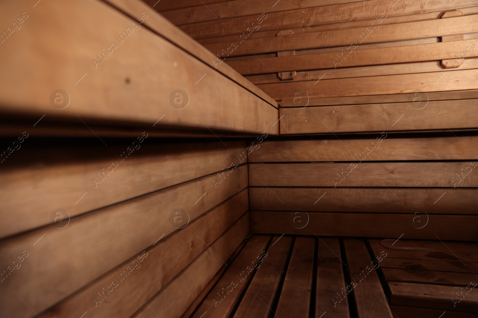 Photo of Empty wooden sauna with bench. Luxury relax