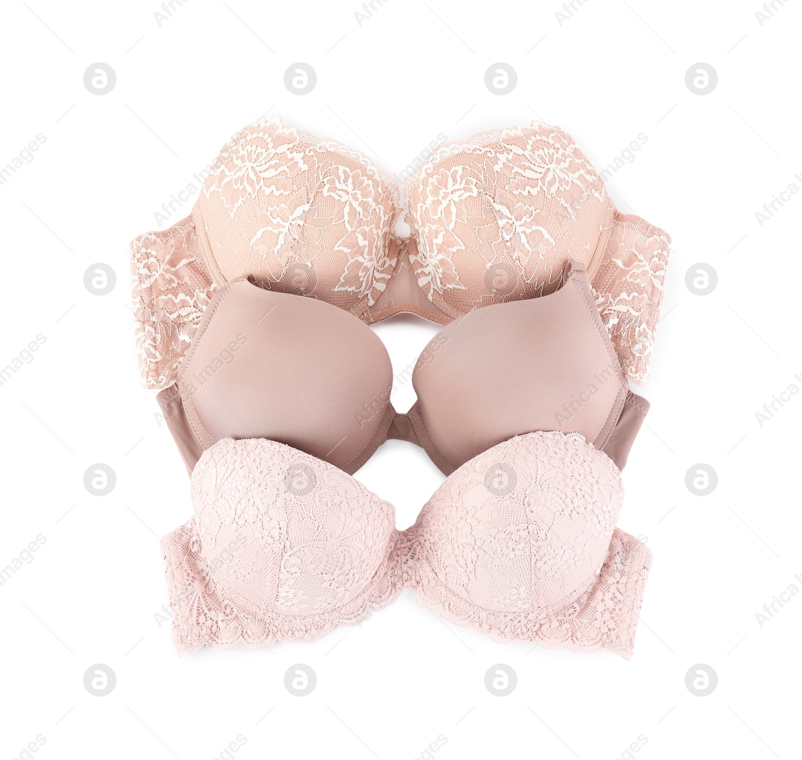 Photo of Three different beautiful bras isolated on white, top view