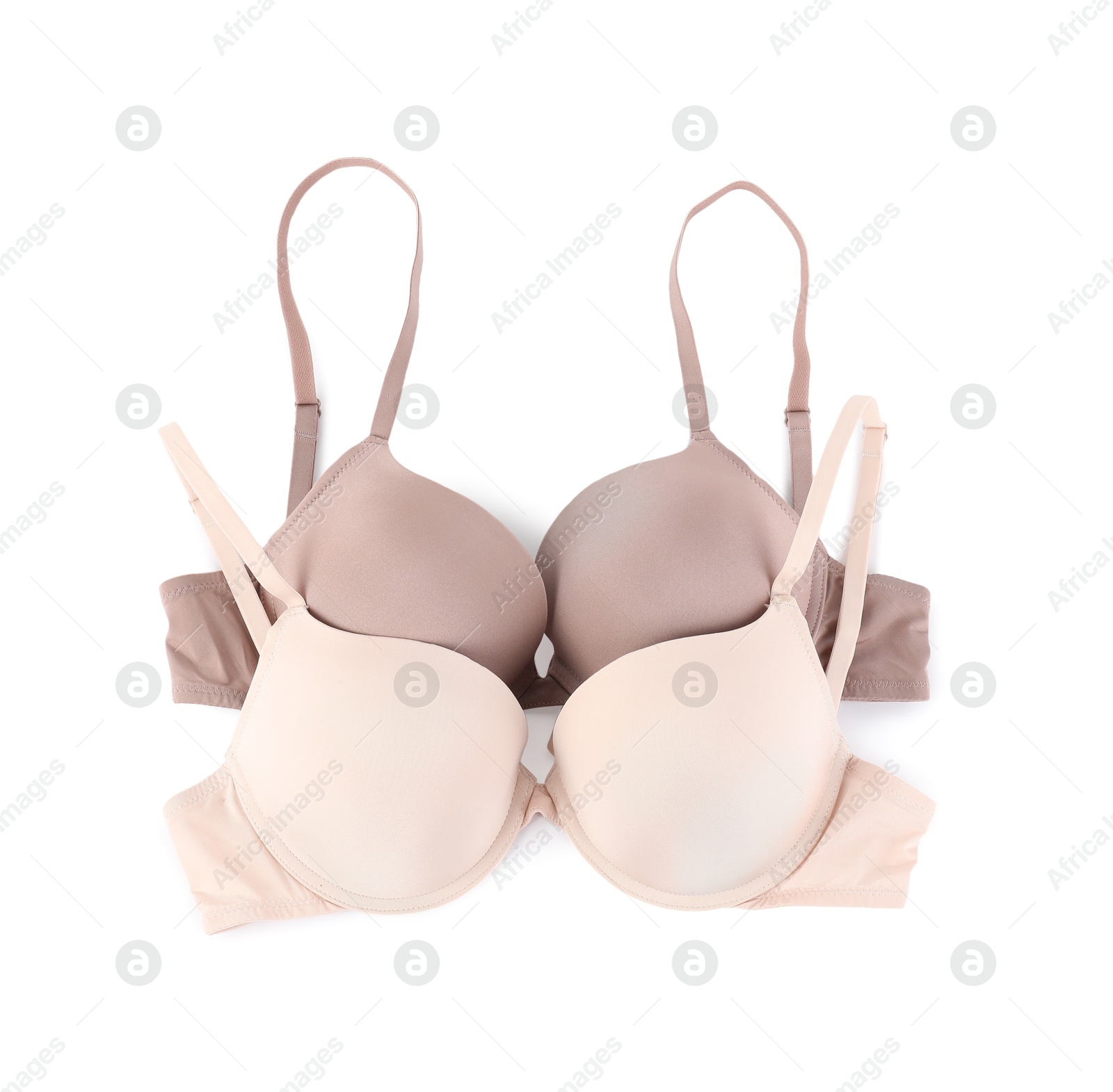 Photo of Two different beautiful bras isolated on white, top view