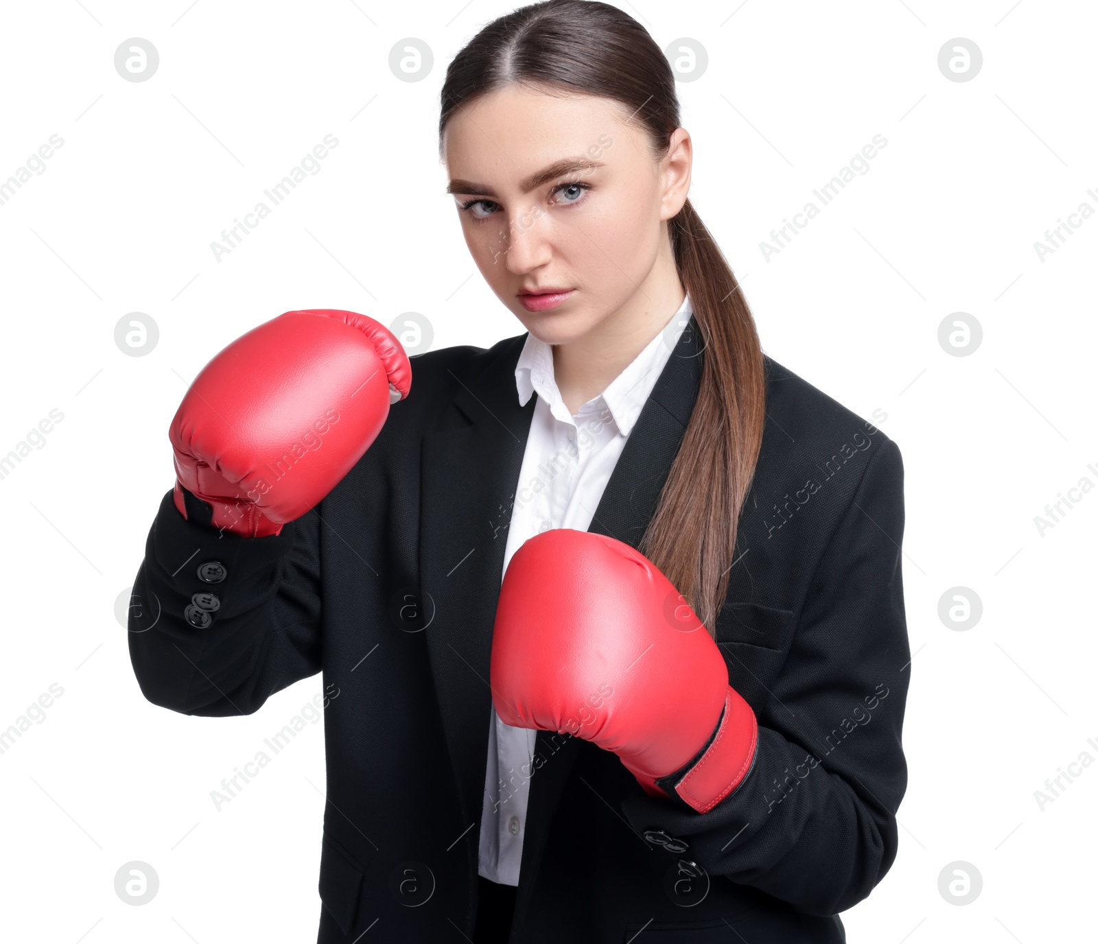 Photo of Competition. Businesswoman in suit wearing boxing gloves on white background