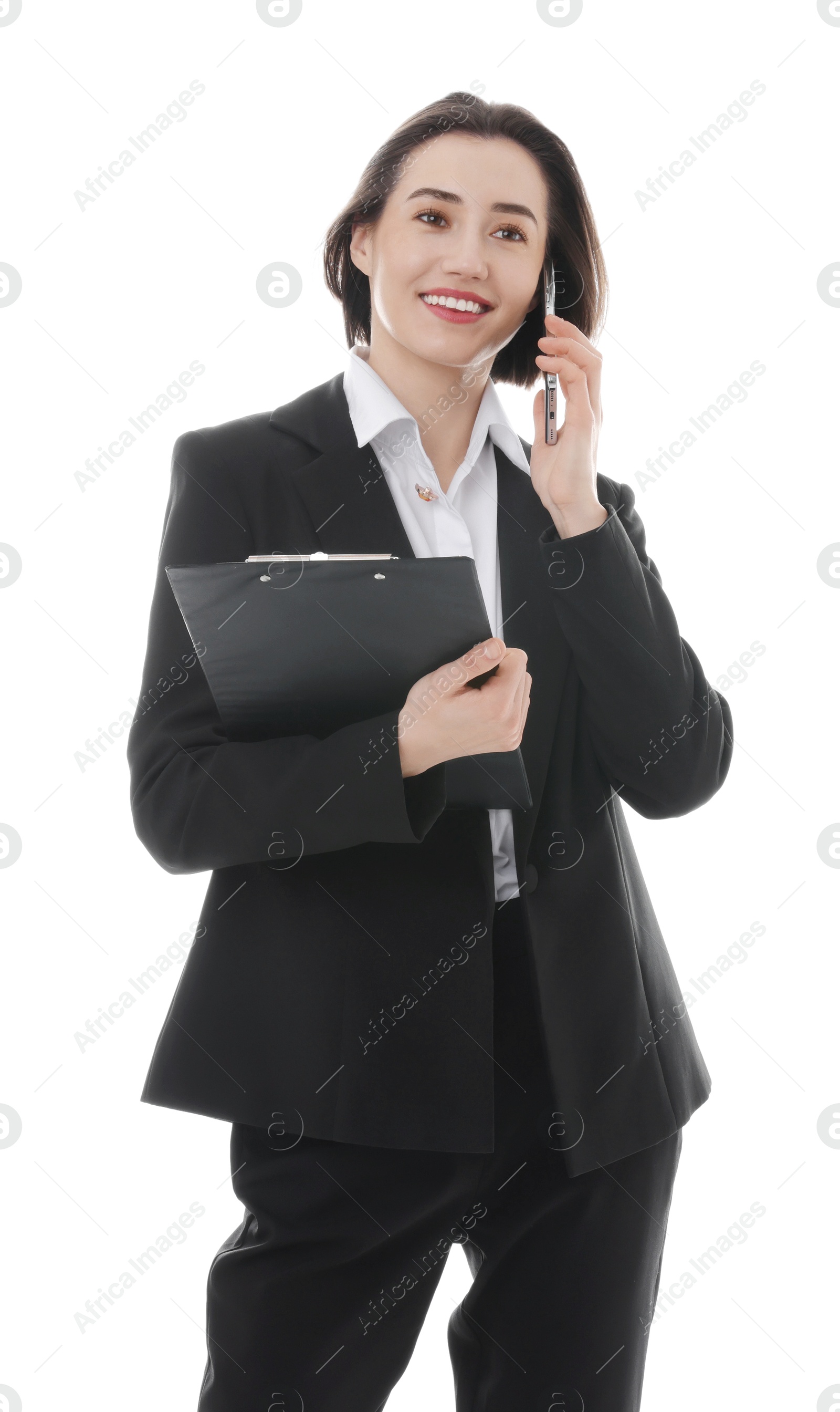 Photo of Smiling secretary with clipboard talking on smartphone against white background