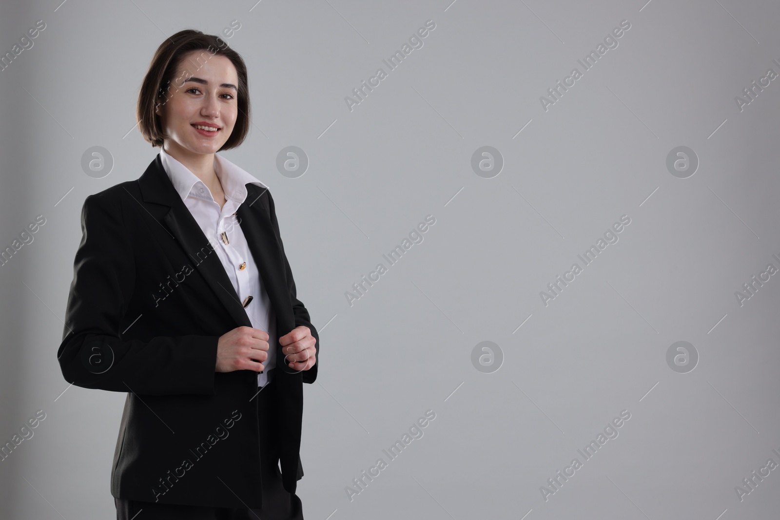 Photo of Portrait of confident secretary on grey background. Space for text