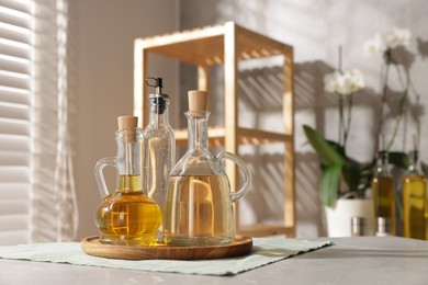 Photo of Oil and vinegar on table in kitchen