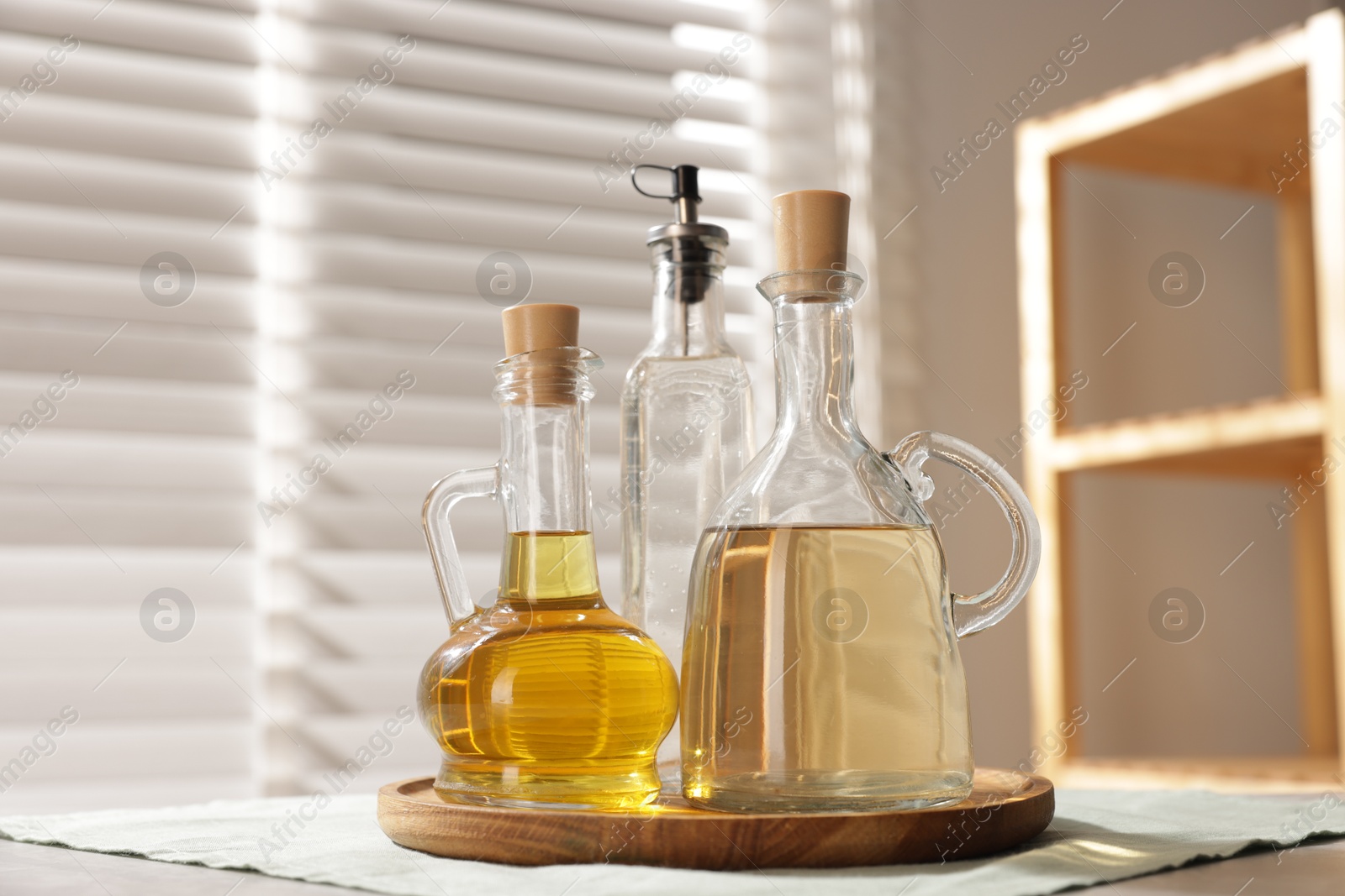 Photo of Oil and vinegar on table in kitchen