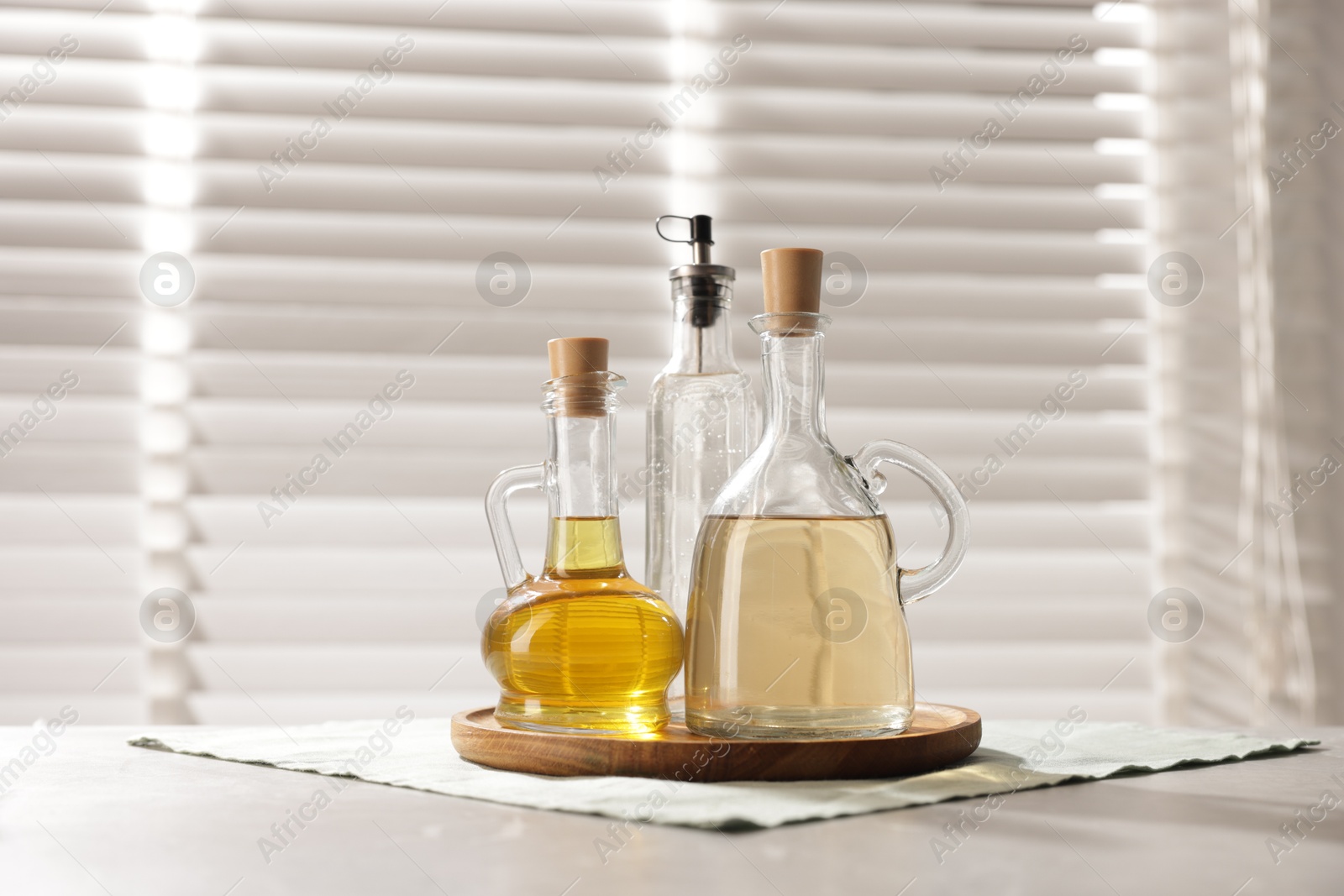 Photo of Oil and vinegar on table in kitchen