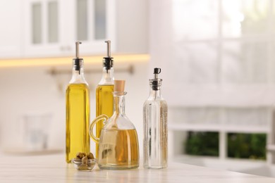 Photo of Salad dressings and olives on table in kitchen. Space for text