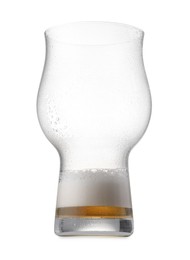 Almost empty glass of beer isolated on white