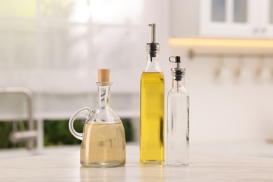 Photo of Oil and vinegar on table in kitchen